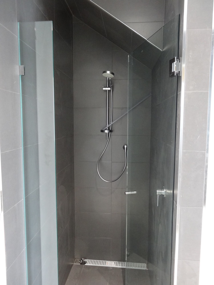 Same bathroom showing the finished shower which is positioned under 